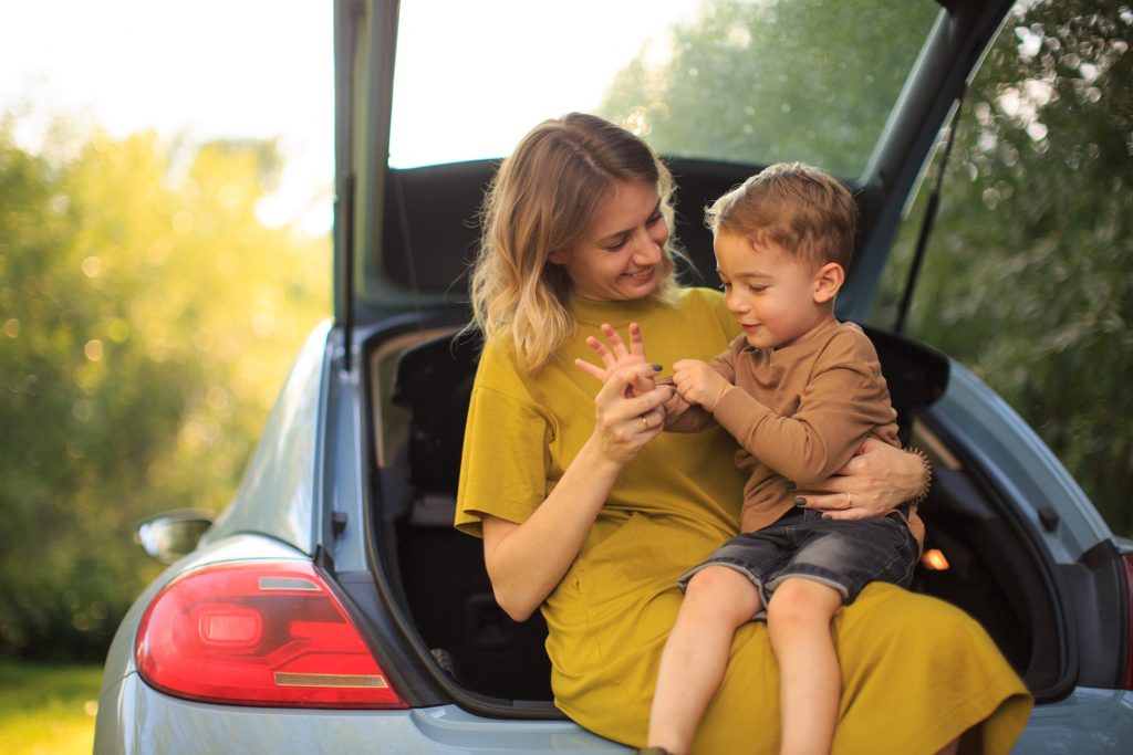 mom and son sitting in a car