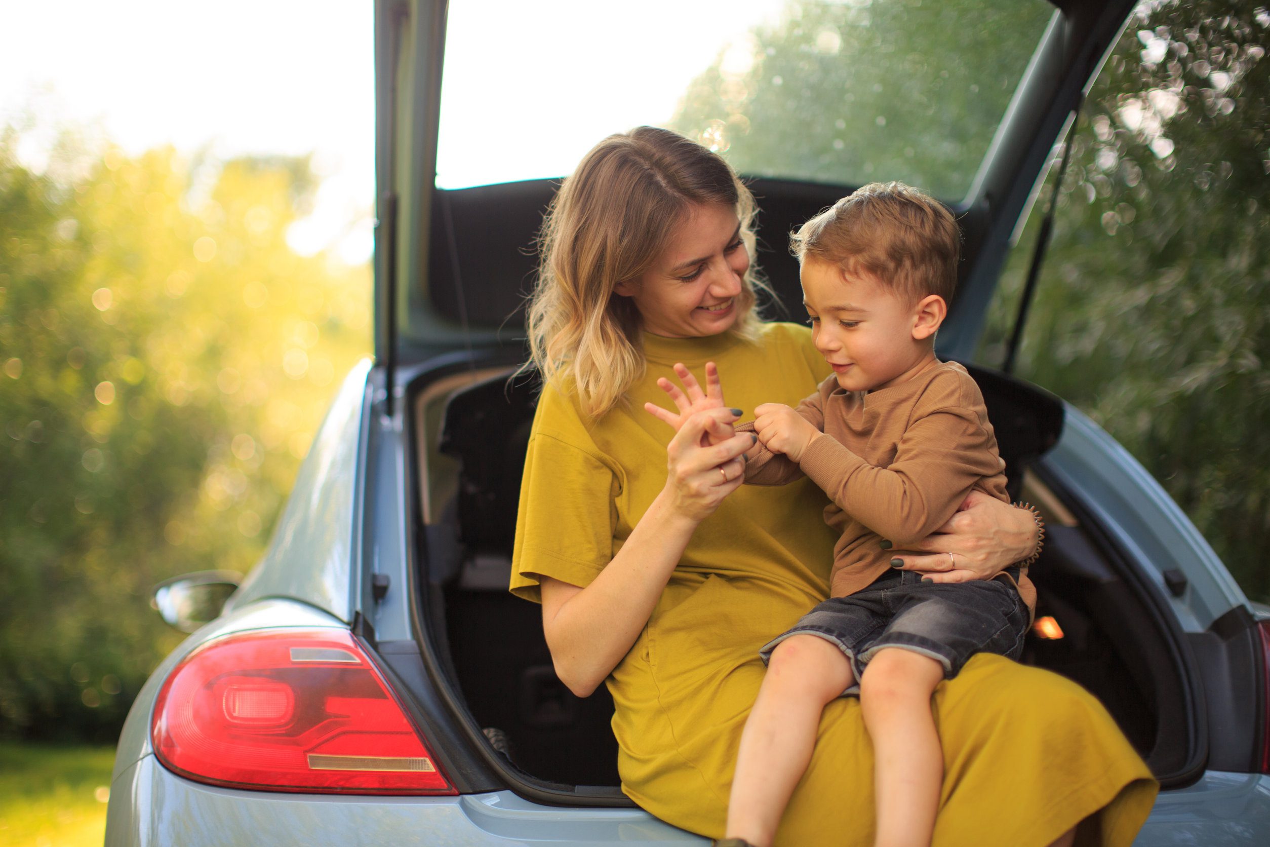 mom and son sitting in a car