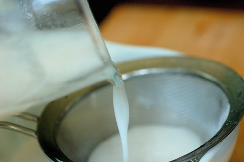 coconut milk being strained